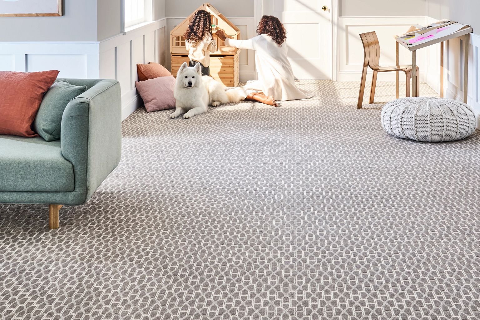 woman, child and dog laying on carpet