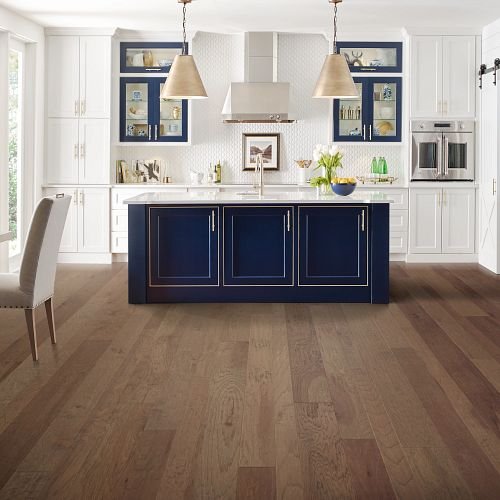 kitchen with hardwood floors white counters and blue accents